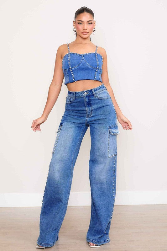 A person stands against a plain backdrop, dressed in a denim crop top and the Pearl High-Rise Wide Leg Cargo Jeans. Their hands rest casually by their sides, highlighting the effortless style of this denim collection.