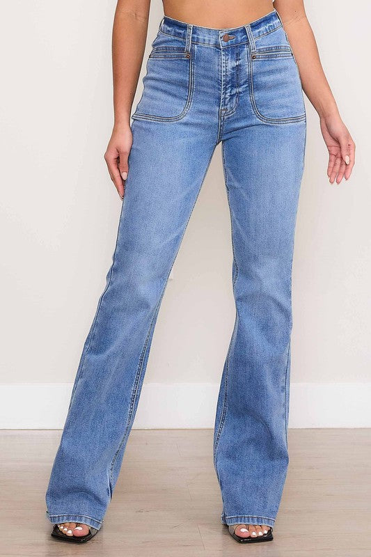 A person wearing Square Pocket Bootcut Jeans crafted from premium denim material, paired with a cropped white top.