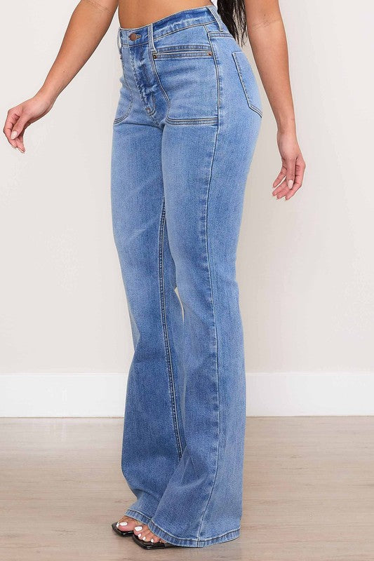 A person wearing Square Pocket Bootcut Jeans crafted from premium denim material, paired with a cropped white top.