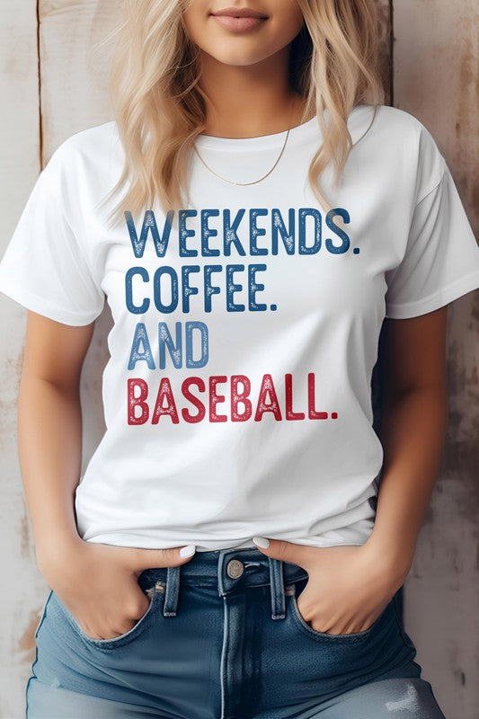 A person with blonde hair stands against a wooden background, wearing the Weekends. Coffee. and Baseball Graphic Tee, showcasing its bold blue and red lettering that proudly states "WEEKENDS. COFFEE. AND BASEBALL.