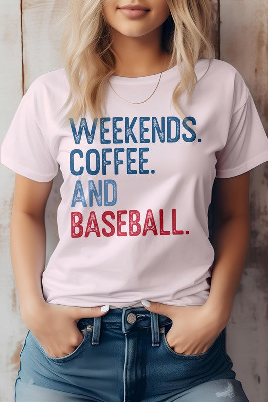 A person with blonde hair stands against a wooden background, wearing the Weekends. Coffee. and Baseball Graphic Tee, showcasing its bold blue and red lettering that proudly states "WEEKENDS. COFFEE. AND BASEBALL.