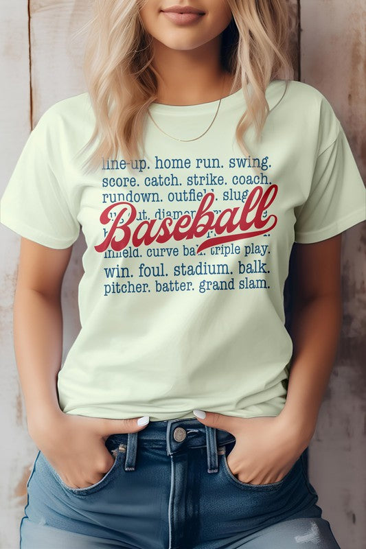 A person wearing the "Line Up, Home Run, Baseball Graphic Tee," which features baseball-related terms like "line-up," "home run," "coach," and "grand slam." The word "Baseball" is prominently displayed in red script. This t-shirt, perfect for sports enthusiasts, is made of eco-friendly materials.