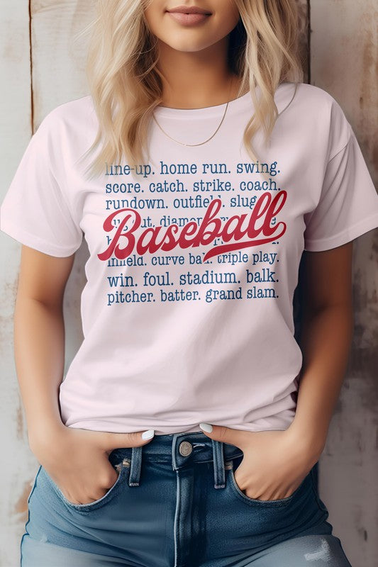 A person wearing the "Line Up, Home Run, Baseball Graphic Tee," which features baseball-related terms like "line-up," "home run," "coach," and "grand slam." The word "Baseball" is prominently displayed in red script. This t-shirt, perfect for sports enthusiasts, is made of eco-friendly materials.