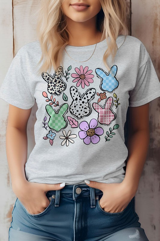 A person wearing the "Boho Easter Bunny Cute Flowers Retro, Graphic Tee," which features a colorful design with five patterned bunny outlines and various flowers, showcasing a boho Easter bunny vibe.