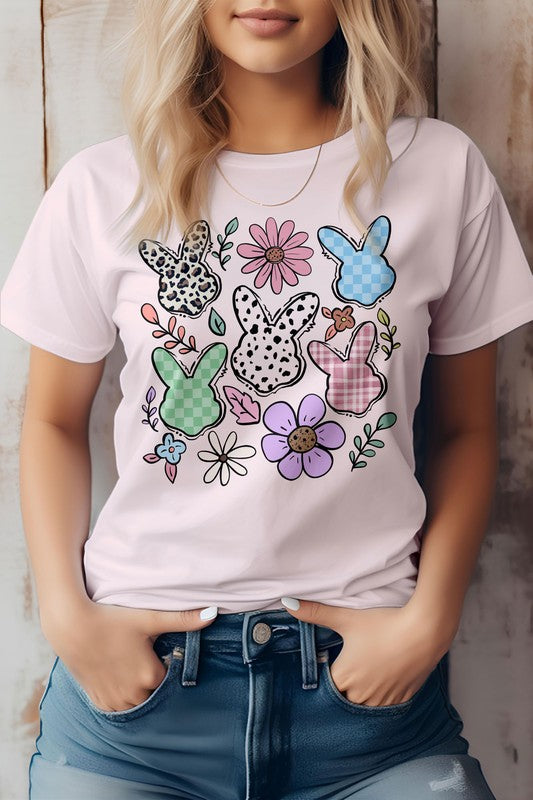 A person wearing the "Boho Easter Bunny Cute Flowers Retro, Graphic Tee," which features a colorful design with five patterned bunny outlines and various flowers, showcasing a boho Easter bunny vibe.