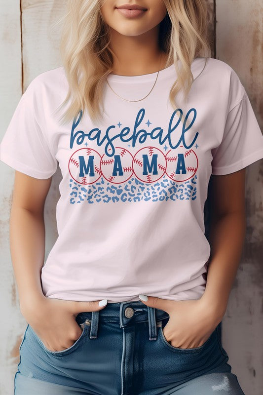 A woman wearing a Baseball Mama Graphic Tee featuring a baseball and leopard print design in light grey, standing with her hands in the pockets of her jeans, epitomizing the baseball life.