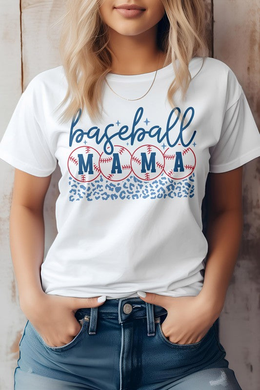 A woman wearing a Baseball Mama Graphic Tee featuring a baseball and leopard print design in light grey, standing with her hands in the pockets of her jeans, epitomizing the baseball life.