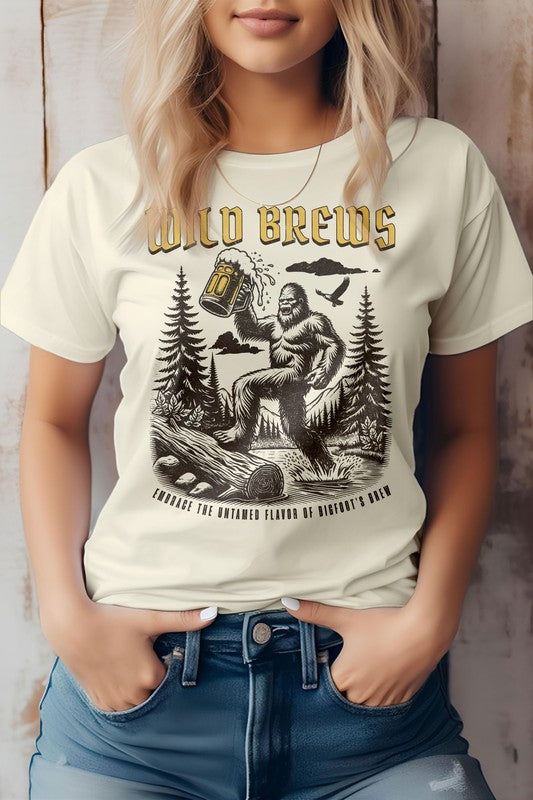 A person wearing an eco-friendly "Wild Brews, Bigfoot Graphic Tee," which features a Bigfoot illustration holding a beer mug amidst a forest setting with the text "Embrace the Untamed Flavor of Bigfoot's Brew.