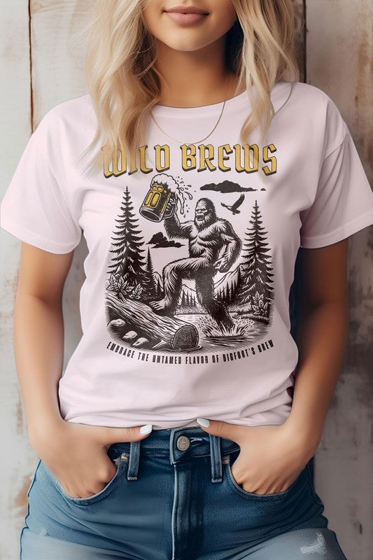 A person wearing an eco-friendly "Wild Brews, Bigfoot Graphic Tee," which features a Bigfoot illustration holding a beer mug amidst a forest setting with the text "Embrace the Untamed Flavor of Bigfoot's Brew.