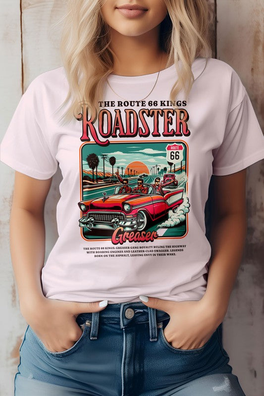 A person wearing the "Roadster Royalty, Retro Vintage Graphic Tee," which features vintage-style artwork promoting Route 66 with a red roadster and text reading "Roadster" and "Greaser." The unisex fit T-shirt is made from eco-friendly materials. The person has their hands in their jean pockets.