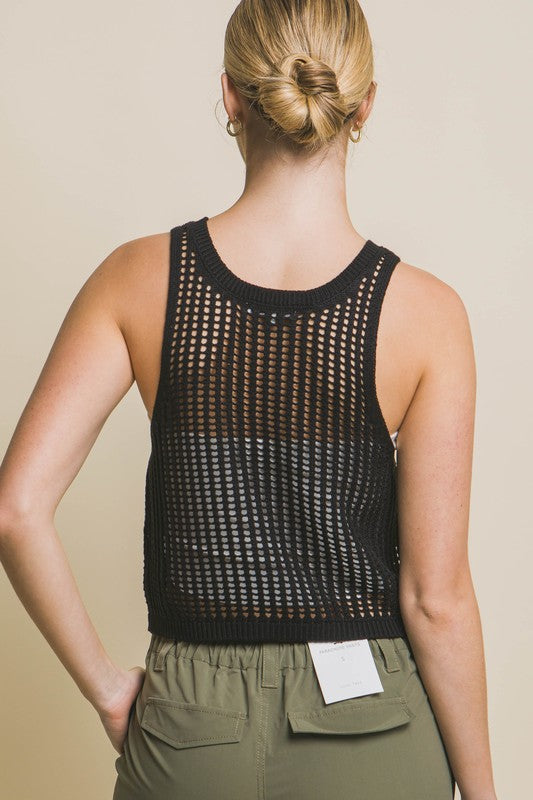 A person poses in a beige Sleeveless Open Knit Crop Top paired with tan drawstring pants against a light background.