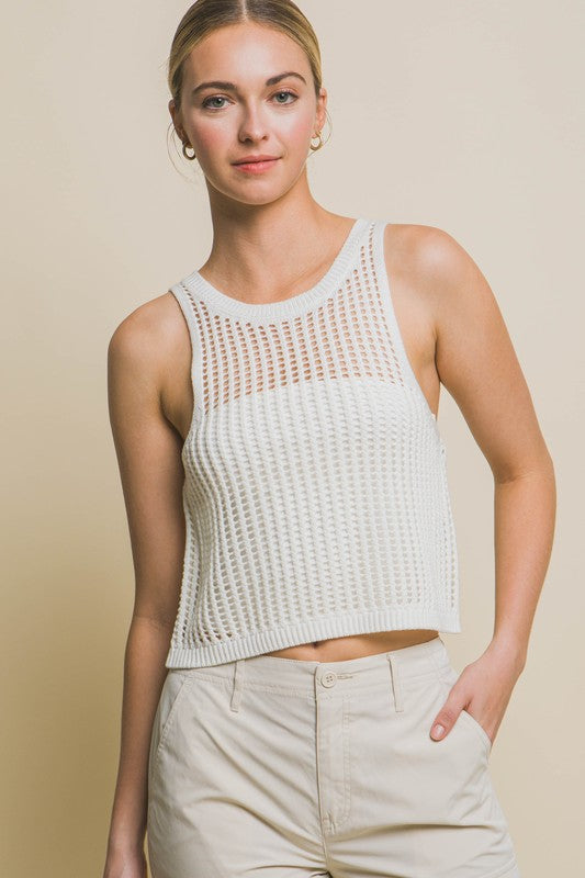 A person poses in a beige Sleeveless Open Knit Crop Top paired with tan drawstring pants against a light background.