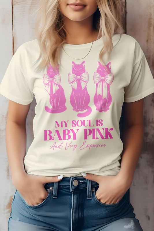 A person wearing a light pink Vintage Coquette Cat Graphic Tee featuring three pink cats with bows and the text, "MY SOUL IS BABY PINK And Very Expensive.