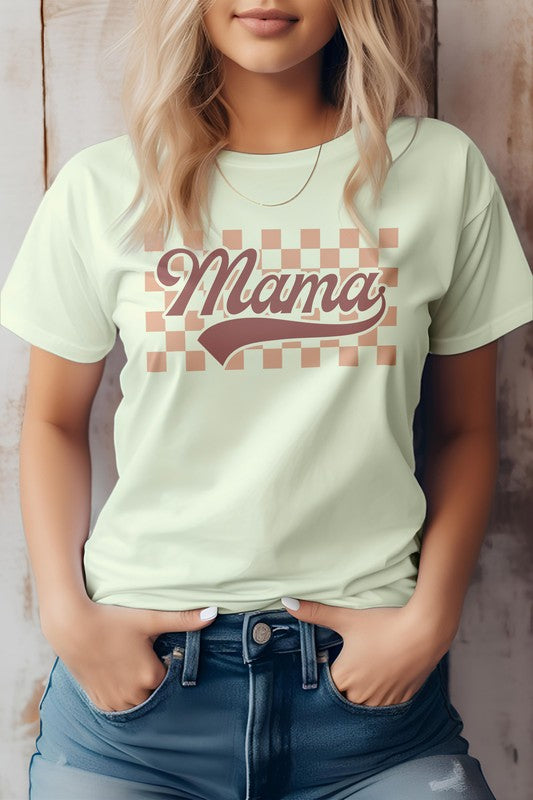 A person wearing a light-colored "Mama Retro Checkered Graphic Tee" with the words "Mama Retro" printed in a retro font stands against a wooden background, embodying the perfect vibe for Mother's Day.