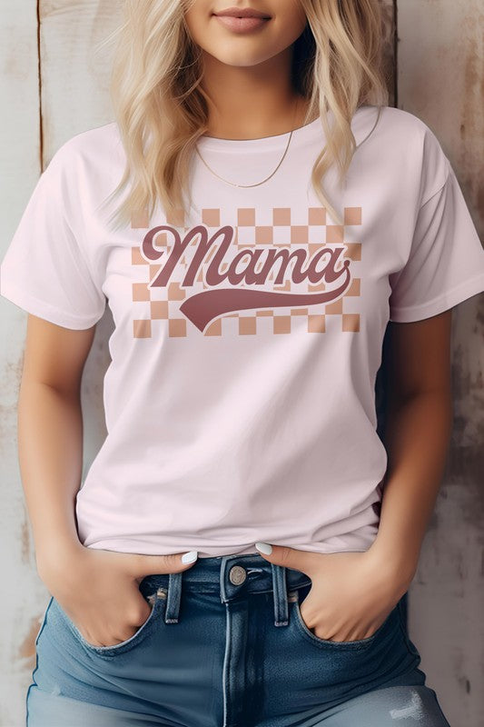 A person wearing a light-colored "Mama Retro Checkered Graphic Tee" with the words "Mama Retro" printed in a retro font stands against a wooden background, embodying the perfect vibe for Mother's Day.