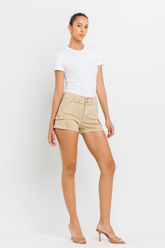 A person wearing High Rise Cargo Shorts in beige and a white top, standing against a plain white background.