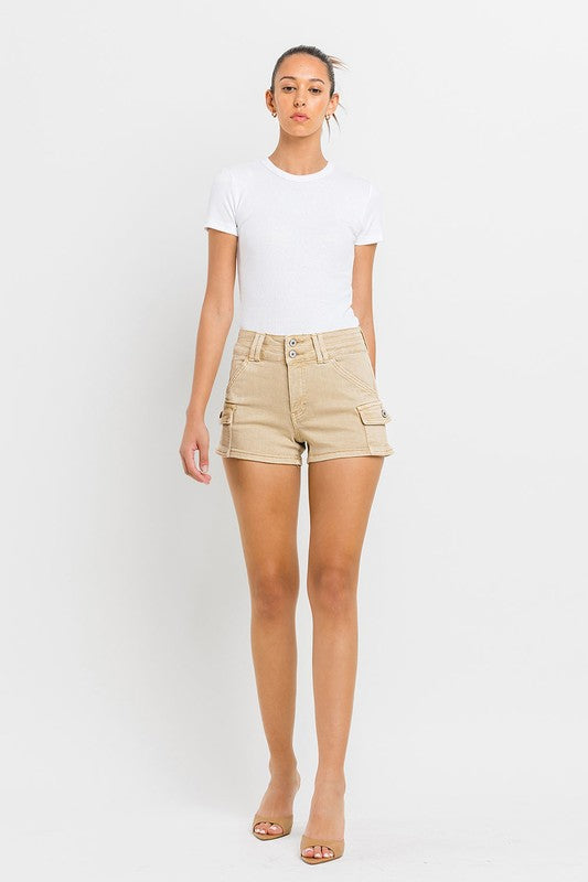 A person wearing High Rise Cargo Shorts in beige and a white top, standing against a plain white background.