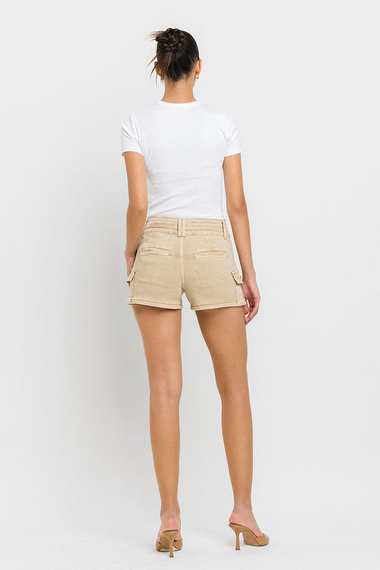 A person wearing High Rise Cargo Shorts in beige and a white top, standing against a plain white background.