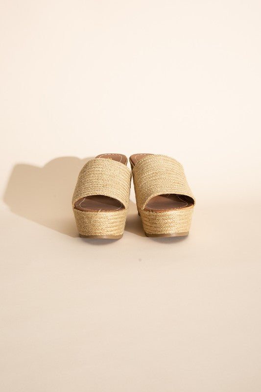 A pair of Bounty-S Wedge Platform Heels featuring a beige woven straw-like texture, open toe straps, and brown insoles.