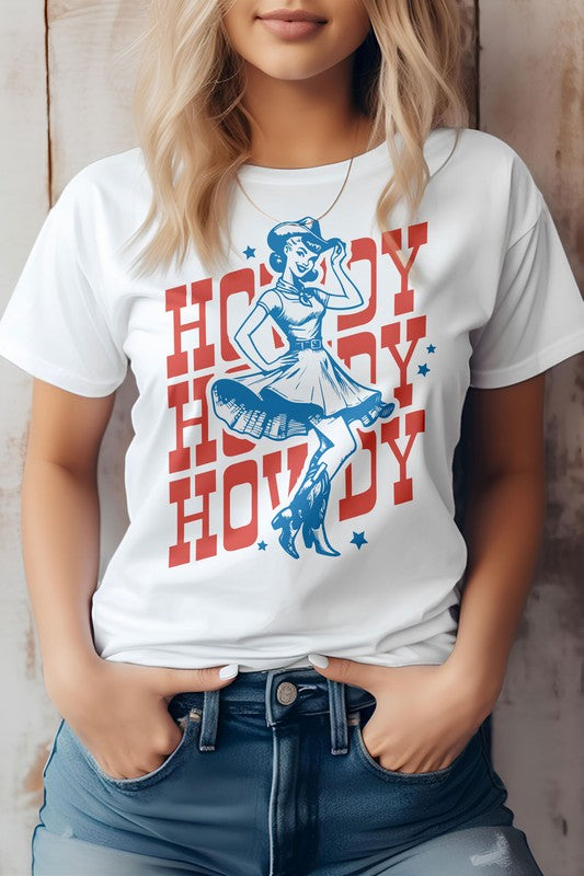 Woman wearing a light gray "Howdy Howdy Howdy, Retro Western Graphic Tee" featuring a cowgirl illustration, paired with denim shorts.