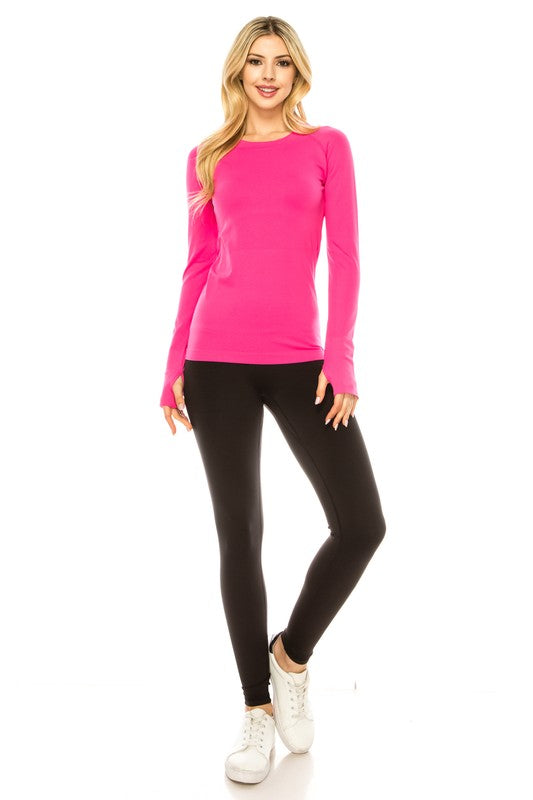 A person is standing in a bright yellow Long Sleeve Workout Shirt for Women, paired with black leggings and white sneakers, posing against a white background. This outfit perfectly showcases stylish athletic wear.