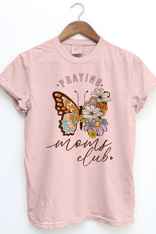 The Praying Moms Club Retro Vintage Garment Dye Tee is a beige graphic top with rolled sleeves, showcasing a vintage wash design of a butterfly and flowers, along with the text "Praying Moms Club." It's an ideal gift for Mother's Day.