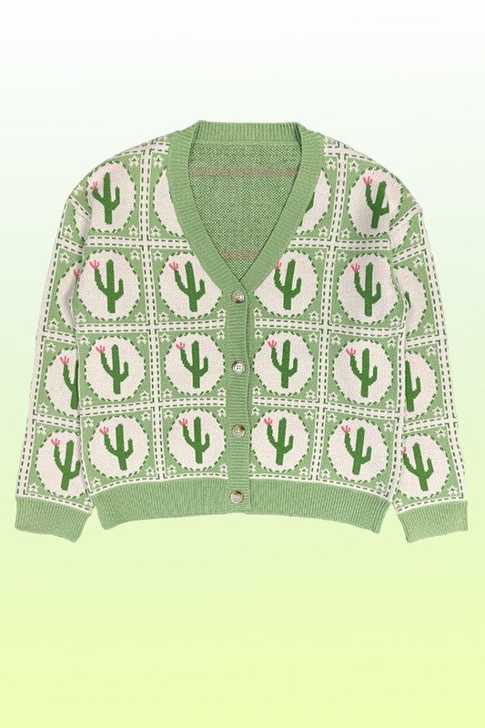 The PLUS SIZE Cactus Tiled Knit Cardigan features a V-neck, full-length sleeves, and a button-down front, adorned with a white and green cactus intarsia pattern. Perfectly tailored for plus sizing.