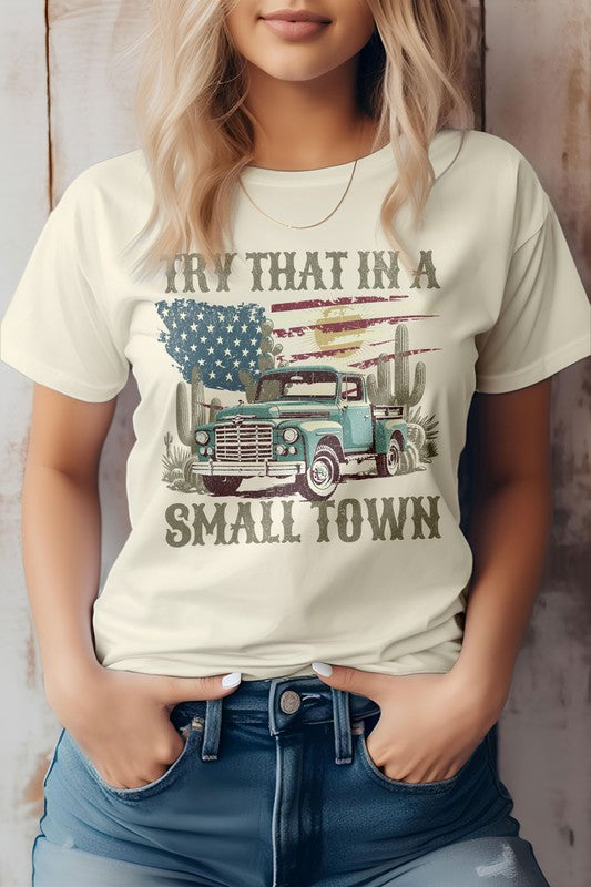 Sporting a Western graphic tee named "Try That in a Small Town," this eco-friendly design features an old truck, cacti, and an American flag theme, perfectly capturing the essence of cowboy style.