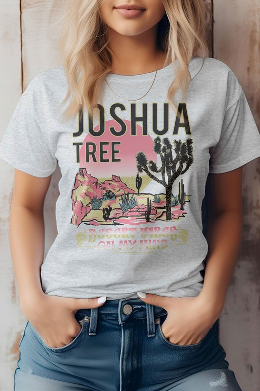 A person wearing the eco-friendly Joshua Tree National Park Graphic Tee displays a desert landscape, perfect for a camping adventure.