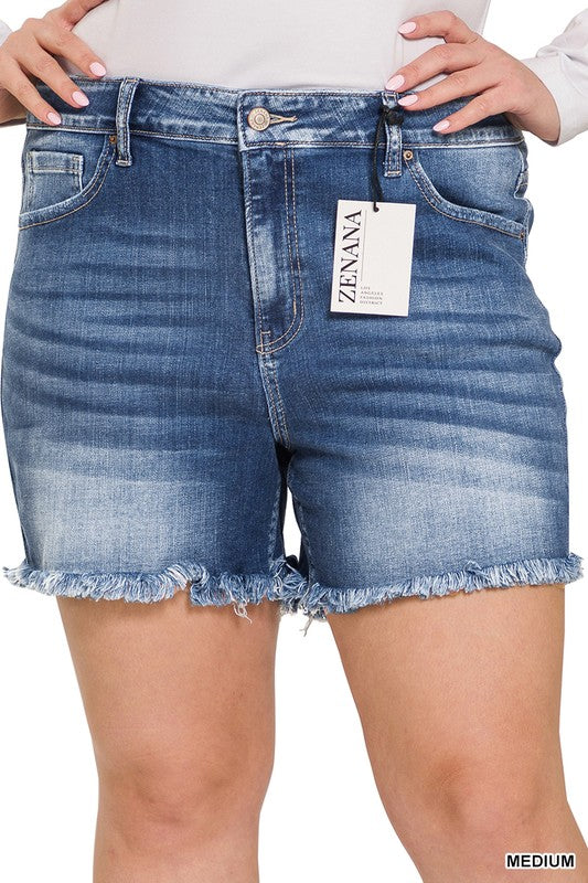 A person is wearing Zenana's Plus Mid Rise Raw Frayed Hem Denim Shorts in blue.