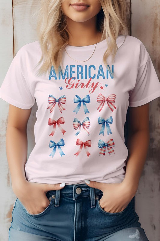 A person sporting the Patriotic Coquette Bow 4th of July Graphic Tee, featuring nine red, white, and blue bows, is proudly embracing the American flag vibe for Independence Day celebrations.