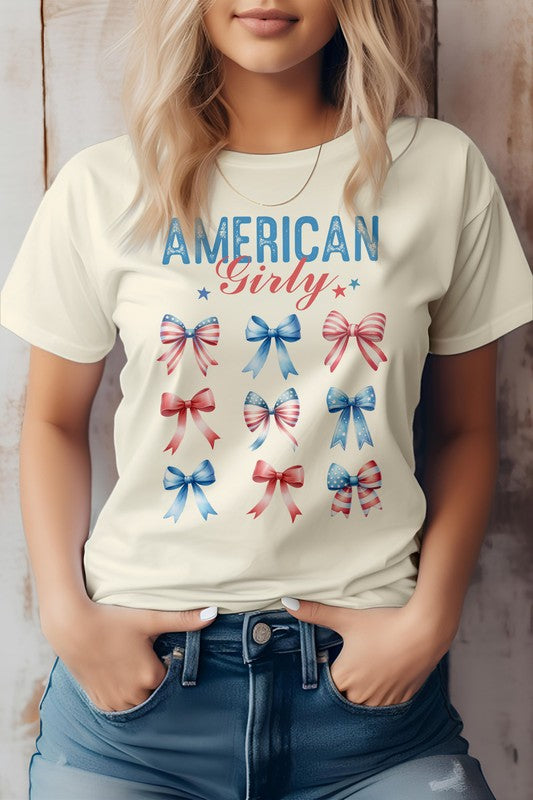 A person sporting the Patriotic Coquette Bow 4th of July Graphic Tee, featuring nine red, white, and blue bows, is proudly embracing the American flag vibe for Independence Day celebrations.