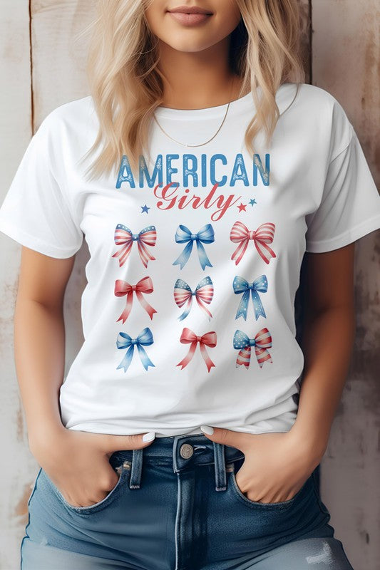 A person sporting the Patriotic Coquette Bow 4th of July Graphic Tee, featuring nine red, white, and blue bows, is proudly embracing the American flag vibe for Independence Day celebrations.