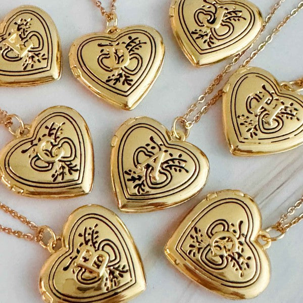 Nostalgic Heart Initial Open Locket Necklace lockets with intricate designs, displayed on a light background, now feature a vintage charm.