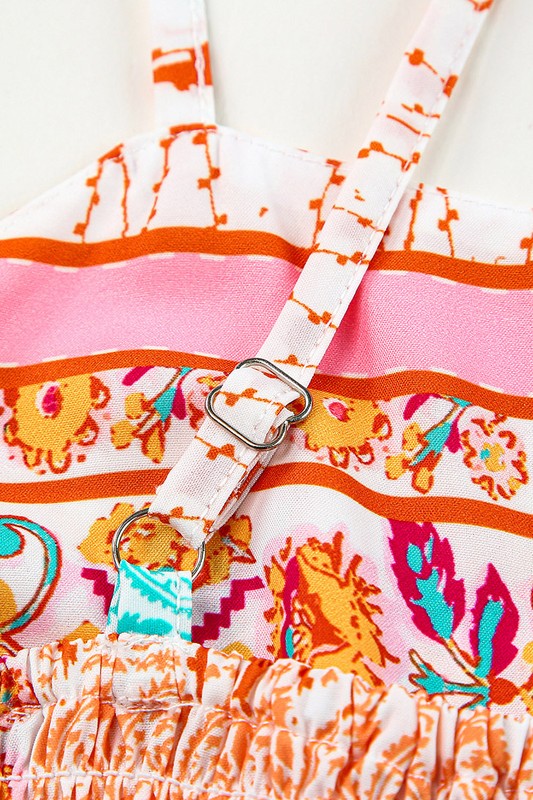 A Patchwork mint coral long sundress, featuring a Bohemian-inspired colorful patchwork print, sleeveless design with spaghetti straps and a square neckline, along with an A-line silhouette, is hanging on a wooden hanger against a plain white background.