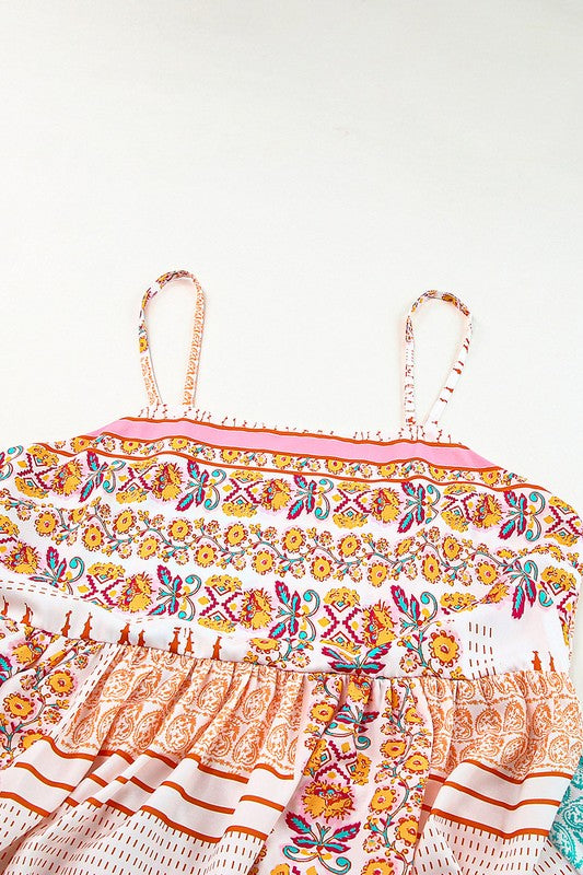 A Patchwork mint coral long sundress, featuring a Bohemian-inspired colorful patchwork print, sleeveless design with spaghetti straps and a square neckline, along with an A-line silhouette, is hanging on a wooden hanger against a plain white background.