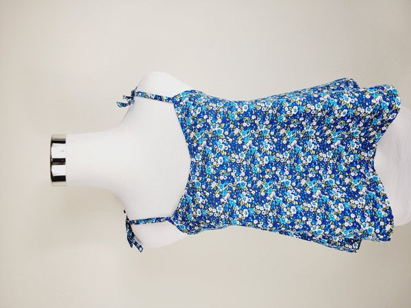 The Cotton Tank Top, a premium quality Boho tank top with adjustable straps, is displayed on a mannequin against a plain background. The sleeveless blue floral design adds an elegant touch to the garment.