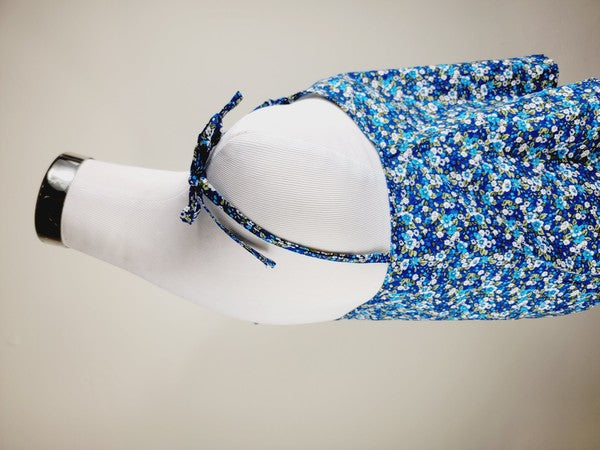 The Cotton Tank Top, a premium quality Boho tank top with adjustable straps, is displayed on a mannequin against a plain background. The sleeveless blue floral design adds an elegant touch to the garment.