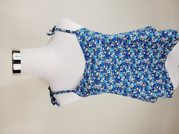 The Cotton Tank Top, a premium quality Boho tank top with adjustable straps, is displayed on a mannequin against a plain background. The sleeveless blue floral design adds an elegant touch to the garment.