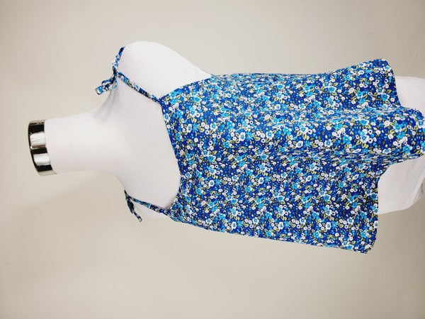 The Cotton Tank Top, a premium quality Boho tank top with adjustable straps, is displayed on a mannequin against a plain background. The sleeveless blue floral design adds an elegant touch to the garment.