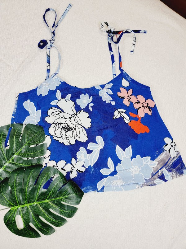 Cotton Tank Top featuring a blue floral sleeveless design with white and light blue flowers, crafted from premium quality cotton, displayed on a dress form against a plain background. This boho tank top comes with adjustable straps.