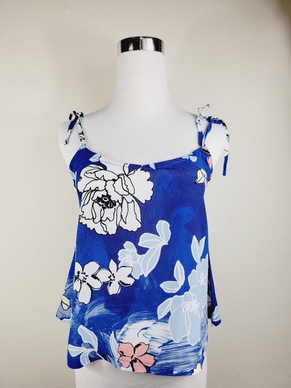 Cotton Tank Top featuring a blue floral sleeveless design with white and light blue flowers, crafted from premium quality cotton, displayed on a dress form against a plain background. This boho tank top comes with adjustable straps.