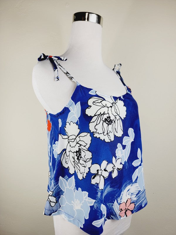 Cotton Tank Top featuring a blue floral sleeveless design with white and light blue flowers, crafted from premium quality cotton, displayed on a dress form against a plain background. This boho tank top comes with adjustable straps.