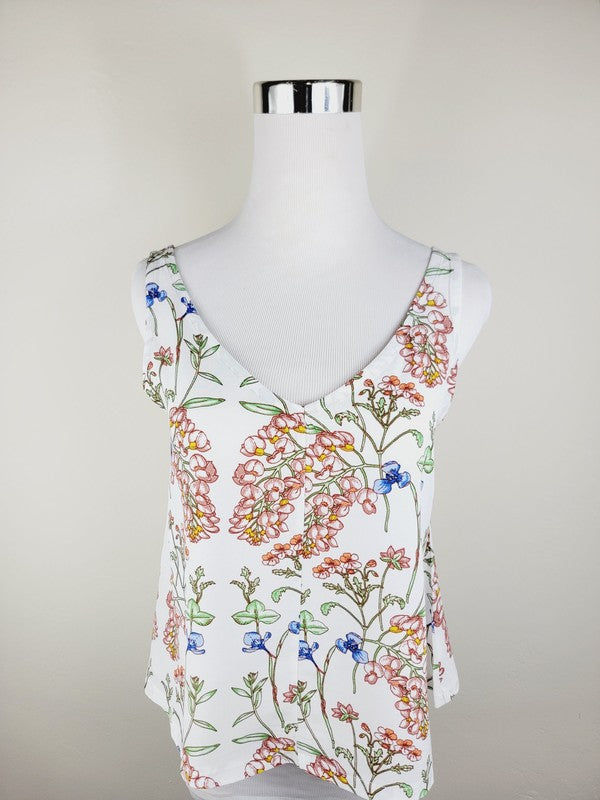 A Cotton Tank Top with adjustable straps, featuring a sleeveless, V-neck design made from Turkish cotton and adorned with a floral print of pink and blue flowers on a mannequin.