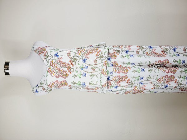 A Cotton Tank Top with adjustable straps, featuring a sleeveless, V-neck design made from Turkish cotton and adorned with a floral print of pink and blue flowers on a mannequin.