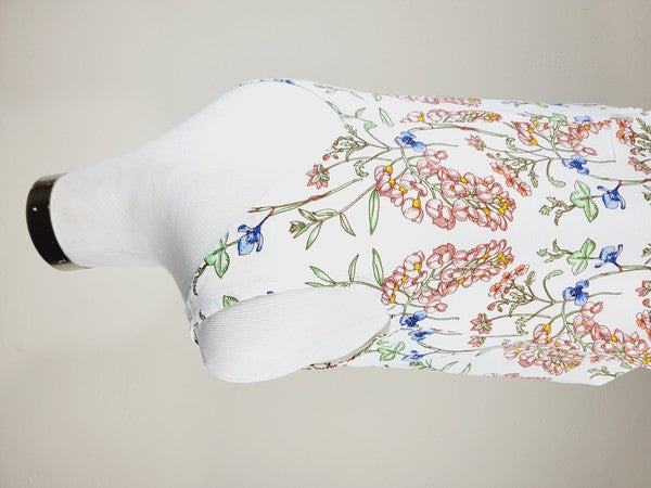 A Cotton Tank Top with adjustable straps, featuring a sleeveless, V-neck design made from Turkish cotton and adorned with a floral print of pink and blue flowers on a mannequin.