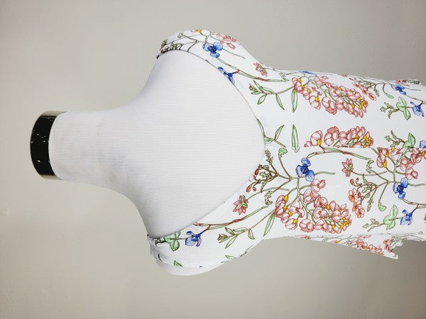 A Cotton Tank Top with adjustable straps, featuring a sleeveless, V-neck design made from Turkish cotton and adorned with a floral print of pink and blue flowers on a mannequin.