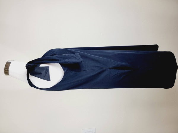 A mannequin displays a Cotton Jersey dress in navy blue with side pockets, featuring a sleeveless design and a large bow on the left shoulder.