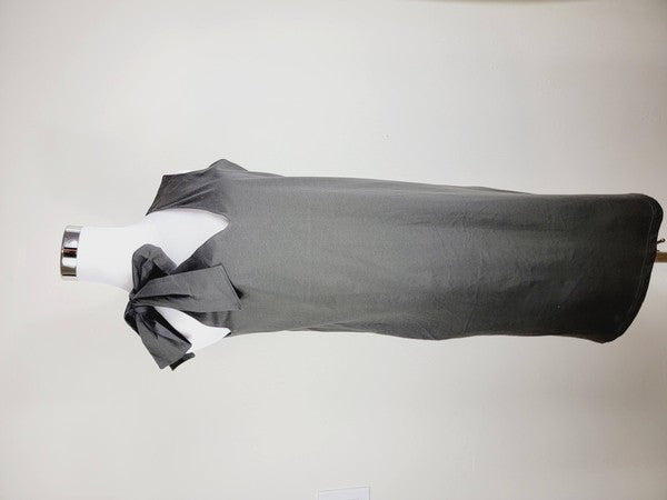 A Cotton Jersey dress in dark grey Turkish cotton, displayed on a mannequin, featuring an adjustable tie shoulder with a large bow on the left side and pockets, set against a plain white background.