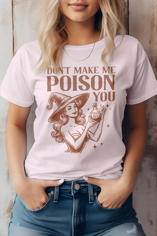 A woman is wearing the "Don't Make Me Poison You Graphic Tee," which showcases a witch with her magic potion and the phrase "Don't Make Me Poison You." Crafted from eco-friendly materials, this T-shirt effortlessly combines style and sustainability.